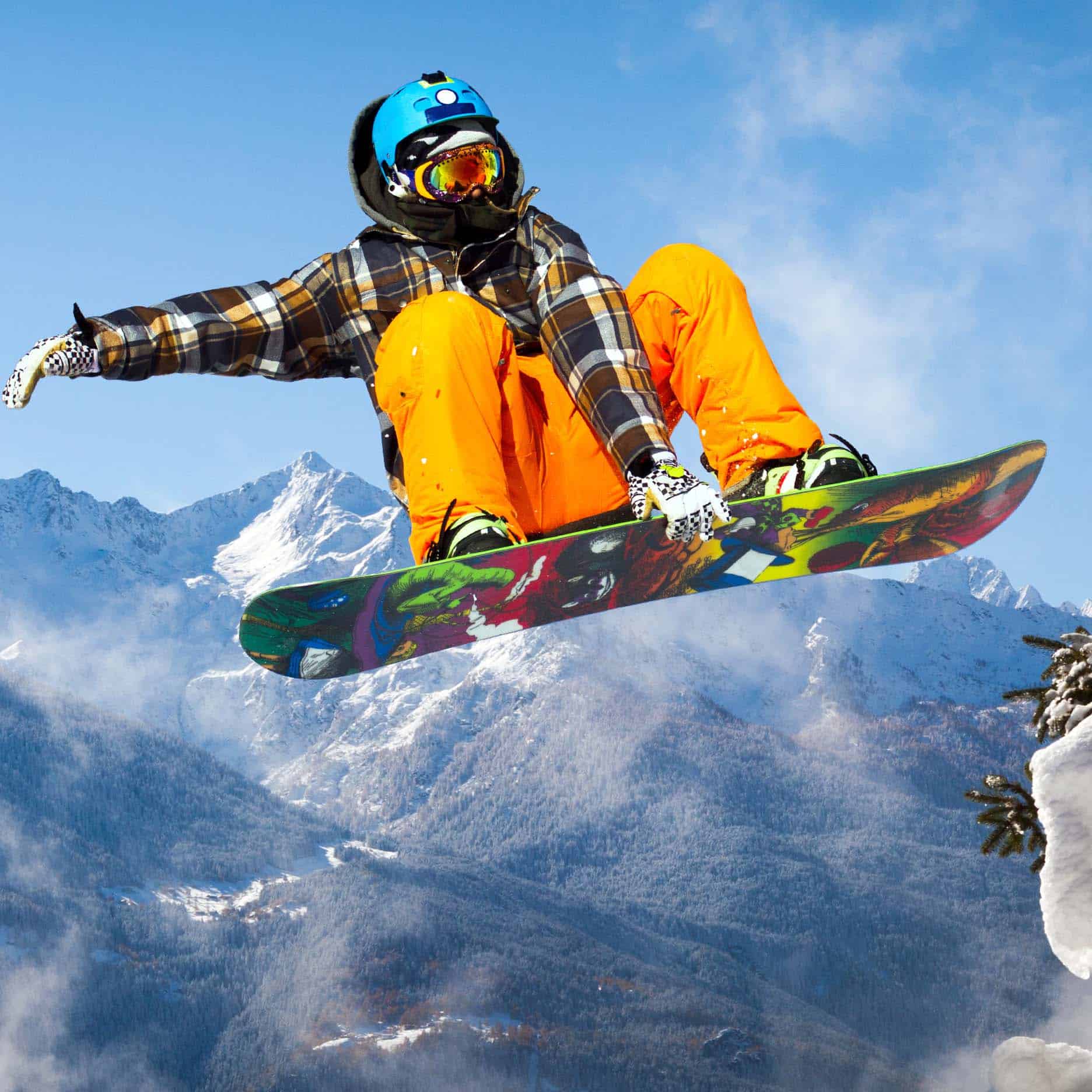 Snowboarder airbore with mountain in background