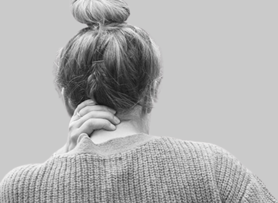 A woman needing neck and back pain treatment following motor vehicle collision