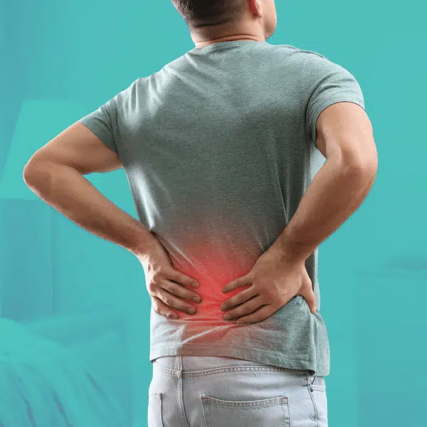 Patient experiencing lower back pain, one of many conditions addressed with chiropractic care